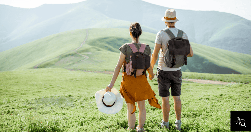 A couple standing on the hiking trail with backpacks