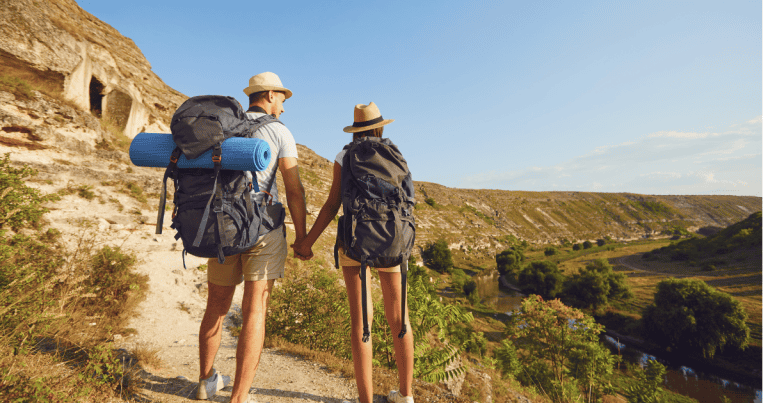 Two people are hiking with backpacks. They used a hiking backpack guide to find the best fit